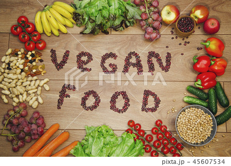 Go vegan concept green organic vegetables & bean on wood background. Go vegan concept green organic vegetables & bean on wood background. 45607534