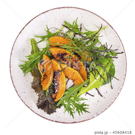 Plate with fresh salad and pumpkin, isolated 45608418
