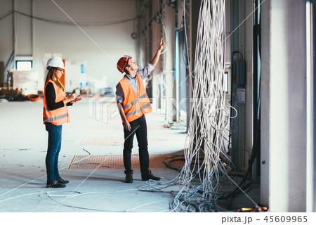 Maintenance Engineers checking cables Maintenance Engineers checking cables 45609965