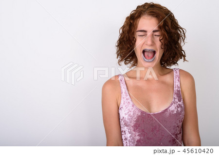 Portrait Of Young Woman Against White Background Portrait Of Young Woman Against White Background 45610420