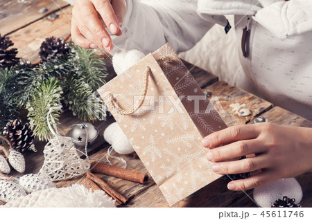 Girl sitting at her desk packaging present Girl sitting at her desk packaging present 45611746