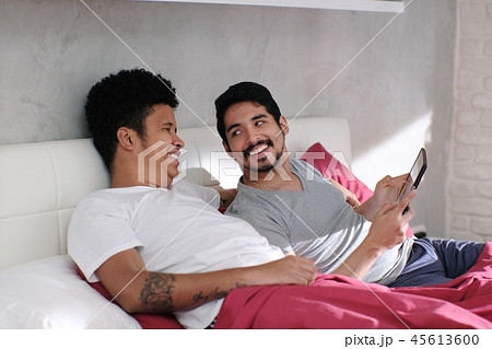 Gay Man Playing Video With Partner In Bed Gay Man Playing Video With Partner In Bed 45613600