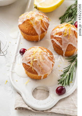 Muffins, cakes with cranberry and lemon on a white board. Muffins, cakes with cranberry and lemon on a white board. 45622366