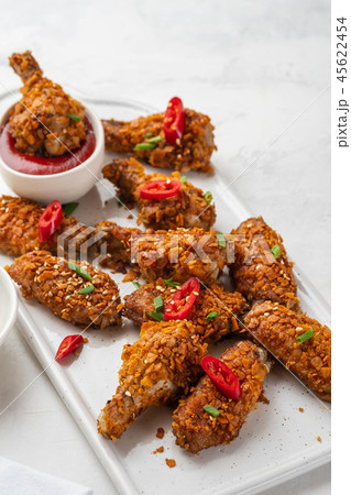 Chicken nuggets with sauce and pepper on a white board. Copy space. 45622454