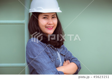 Portrait of engineer woman standing beside ladder Portrait of engineer woman standing beside ladder 45623151