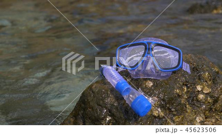 a mask and snorkel on the beach near the sea 45623506