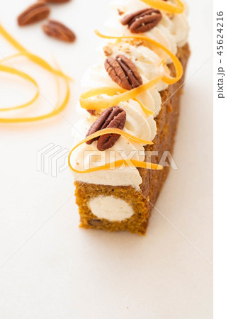 Carrot cake pie, sprinkled with nuts, decorated with cream-colored carrots on white marble. Carrot cake pie, sprinkled with nuts, decorated with cream-colored carrots on white marble. 45624216