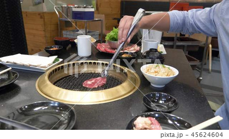 Korean barbecue grill. people cook and eat dishes cooked on a Korean grill in a restaurant. close-up Korean barbecue grill. people cook and eat dishes cooked on a Korean grill in a restaurant. close-up 45624604