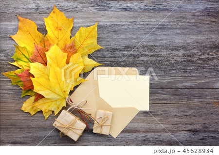 Craft paper envelope with autumn leaves 45628934