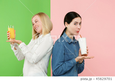 Diet. Dieting concept. Healthy Food. Beautiful Young Women choosing between fruit orange juice and Diet. Dieting concept. Healthy Food. Beautiful Young Women choosing between fruit orange juice and 45629701