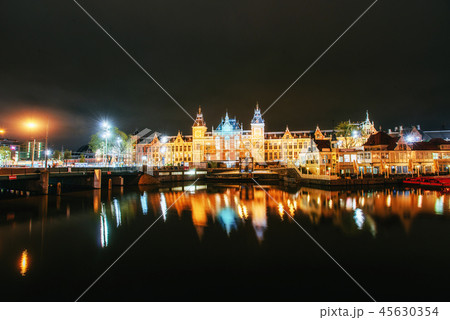 Night illumination of buildings and boats near the water in the canal. 45630354
