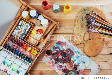 Box of watercolor paints, art brushes on canvas. Box of watercolor paints, art brushes on canvas. 45631599