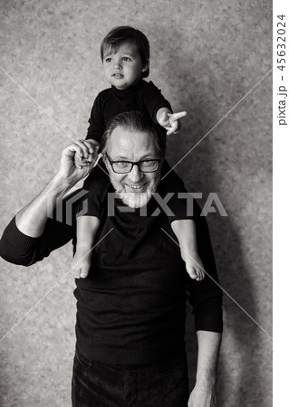 grandfather with beard and glasses with his grandson sitting on the neck 45632024