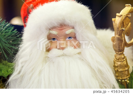 Santa Claus with gifts sitting next to a Christmas tree 45634205