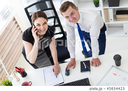 Young people in the office looking at the monitor. 45634423
