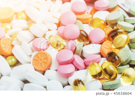Medical colorful pills, capsules or supplements for the treatment and health care on a light 45638604