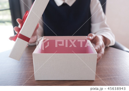Close-up Female's hand opening a gift box, present 45638943