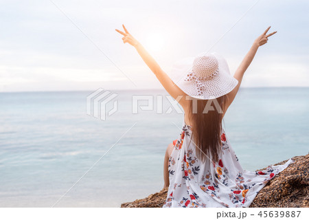 Beauty woman doing cheerful gesture beside the beach. Woman rais Beauty woman doing cheerful gesture beside the beach. Woman rais 45639887