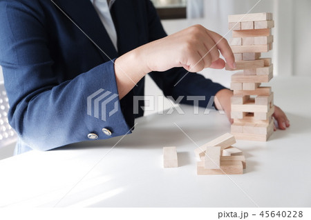 Women place wood blocks symbol of business growth Women place wood blocks symbol of business growth 45640228