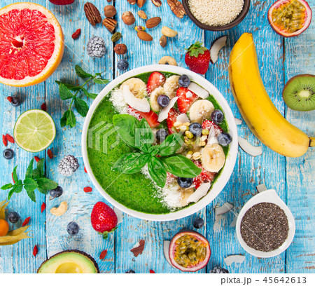 Smoothie bowl with fresh berries, nuts, seeds, fruit and vegetables. Smoothie bowl with fresh berries, nuts, seeds, fruit and vegetables. 45642613