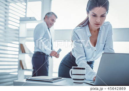 Long-haired beautiful woman working with laptop at office 45642869