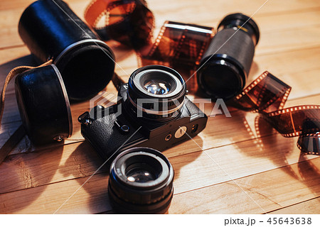 Old photo film and analog camera on table. Roll of photographic . Beautiful vintage design. 45643638