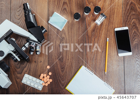 microscope image notebook and phone close-up. 45643707