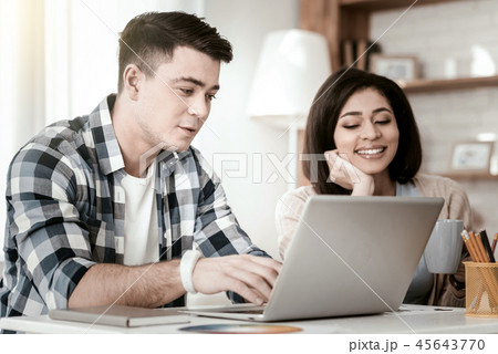 Positive delighted man working on distance at home Positive delighted man working on distance at home 45643770