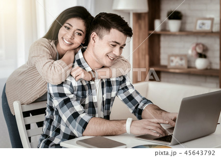 Cheerful African woman embracing her delighted partner Cheerful African woman embracing her delighted partner 45643792