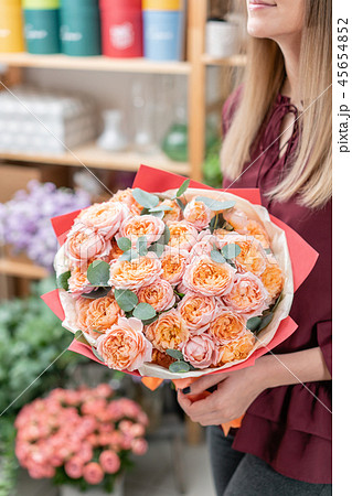 European floral shop. Bouquet of beautiful Mixed flowers in woman hand. Excellent garden flowers in European floral shop. Bouquet of beautiful Mixed flowers in woman hand. Excellent garden flowers in 45654852