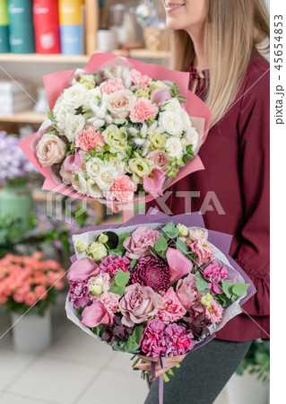 European floral shop. Two Bouquet of beautiful Mixed flowers in woman hand. Excellent garden flowers European floral shop. Two Bouquet of beautiful Mixed flowers in woman hand. Excellent garden flowers 45654853