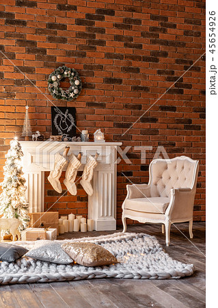 Loft apartments, brick wall with candles and Christmas tree wreath. White wool socks for Santa on 45654926