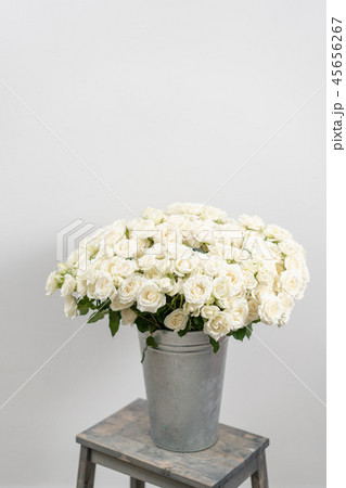 Big luxury bright bouquet on wooden table. Garden spray roses of white color . bouquet in metal vase 45656267