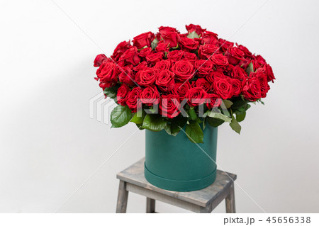 Big luxury bright bouquet on wooden table. One hundred of garden red roses. Color passionately 45656338
