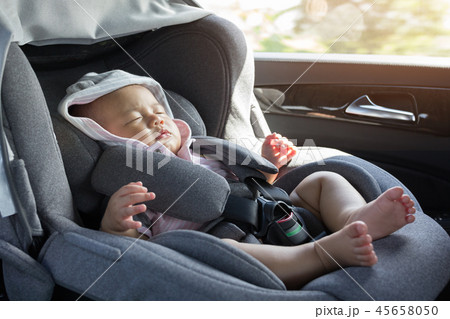 Close Up Asian cute newborn baby sleeping in modern car seat. 45658050