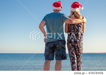 man hugging woman in christmas hats 45658406