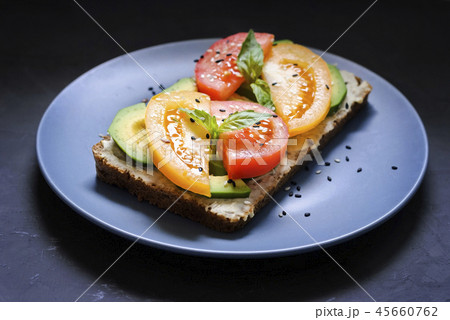 Gourmet tomato and avocado on rye toast dish Gourmet tomato and avocado on rye toast dish 45660762