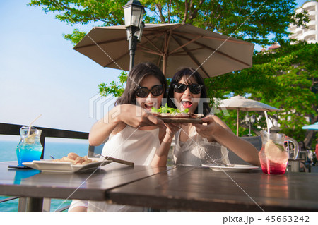 Leisure concept. Beautiful girl is eating at the seaside restaur 45663242