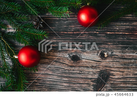 fir branches and red balls, cones on a wooden table top view. Christmas winter background 45664633