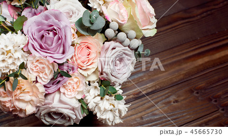 A bouquet of flowers on a wooden brown background. Copy space A bouquet of flowers on a wooden brown background. Copy space 45665730