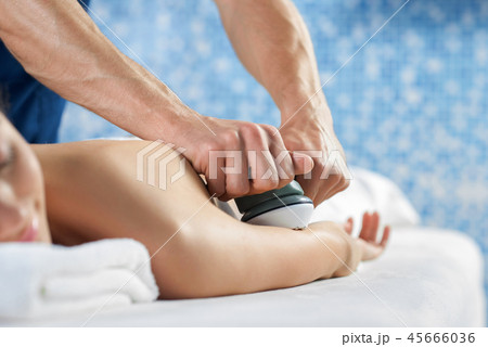 Selective focus of hands of masseur doing massage of arm Selective focus of hands of masseur doing massage of arm 45666036