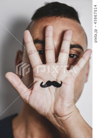man with a mustache painted in his palm 45667814