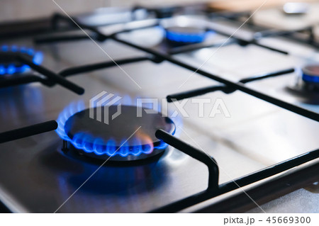 Gas kitchen stove cook with blue flames burning 45669300