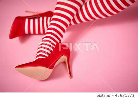 sexy santa woman's legs on a pink background 45671573