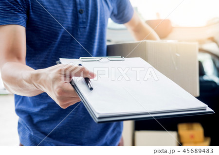 woman courier holding a parcel Shipping Mail appending signature 45689483