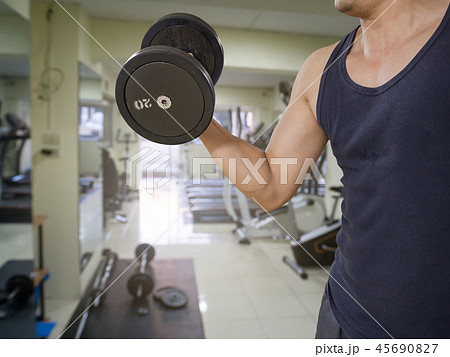 Man training in the gym - dumbbell biceps curl Man training in the gym - dumbbell biceps curl 45690827