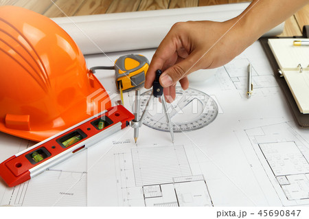 An architect or engineer working on blueprint An architect or engineer working on blueprint 45690847