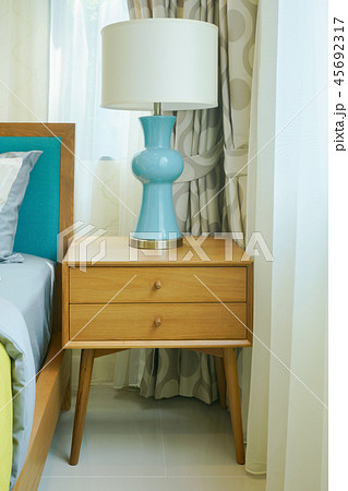 Modern classic reading lamp on wooden night table 45692317