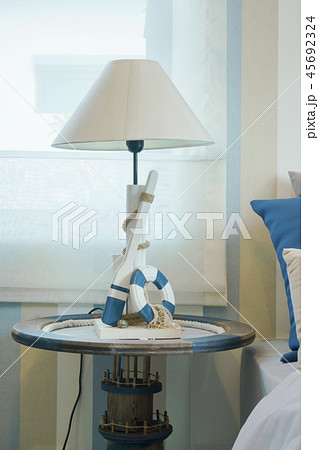White reading lamp on night table in bedroom White reading lamp on night table in bedroom 45692324