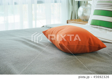 Closeup orange pillow on bed Closeup orange pillow on bed 45692326